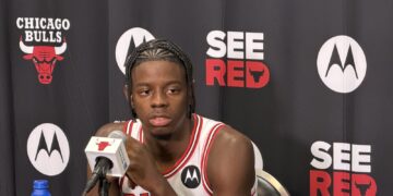 Chicago Bulls rookie Caleb Wilson answers questions at the podium during media day
