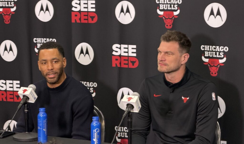 Bulls executive VP Bryson Graham and head coach Tiago Splitter seated at microphones in front of a Chicago Bulls backdrop